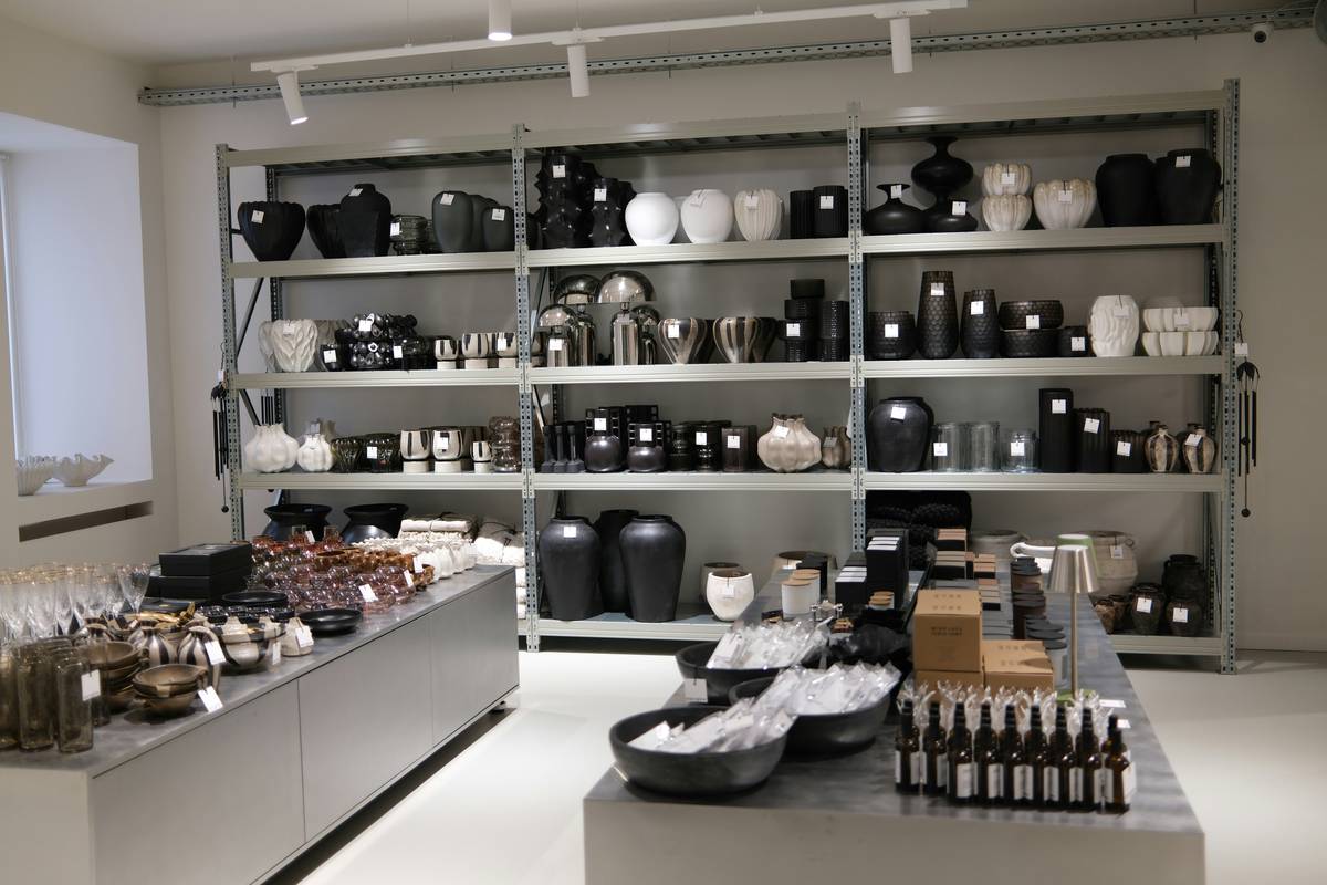 what are retail fixtures showing recessed gimbal fixtures highlighting mannequins and directional track lighting illuminating shelving units in a modern retail showroom